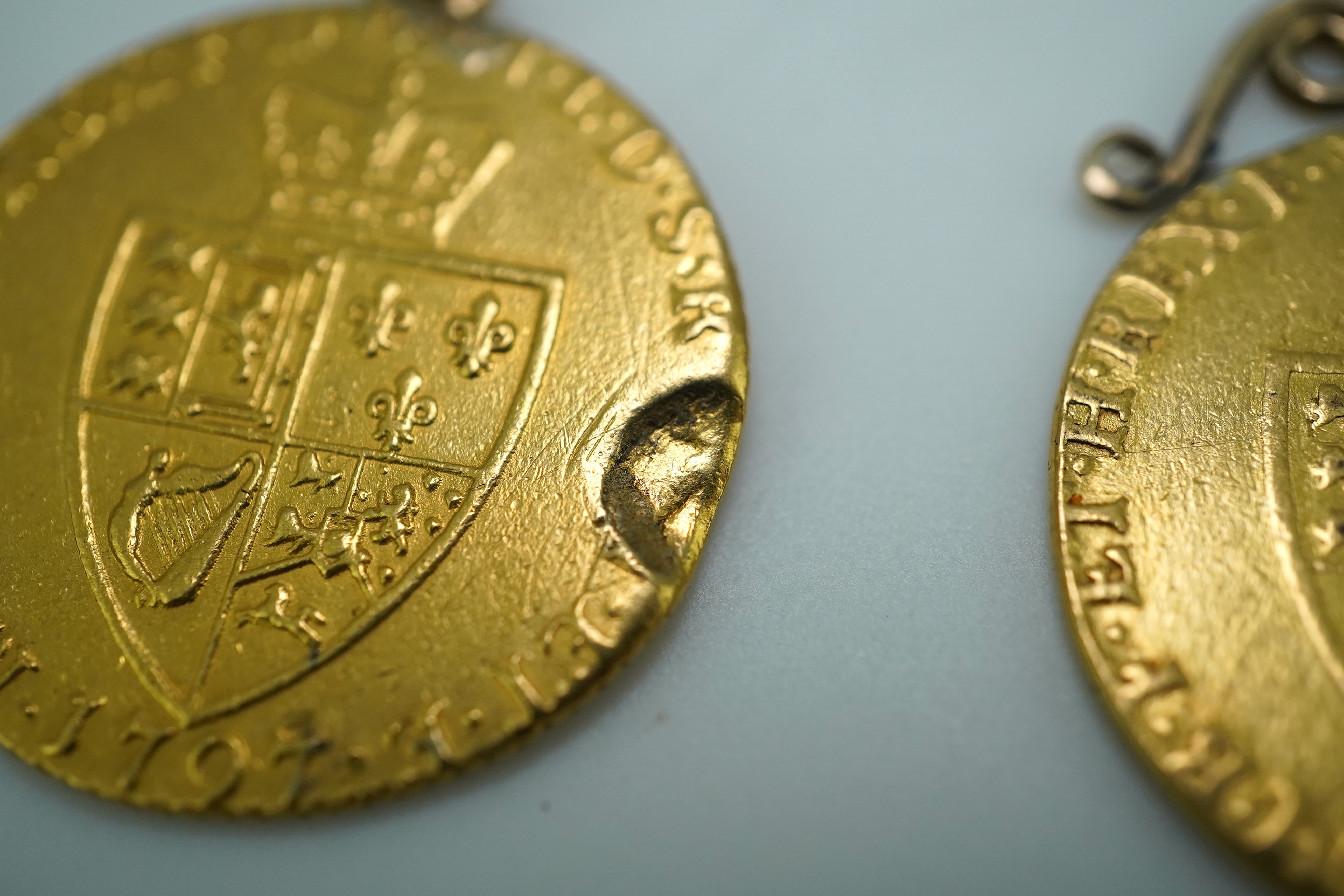 Three George III gold spade guinea coin pendants, late 18th/early 19th century and later